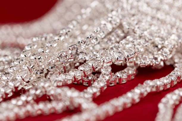 Silver chain on a black leather background.