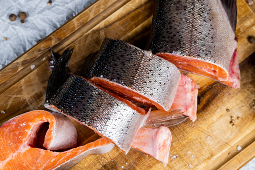 red trout meat in the kitchen, cooking a fish dish with expensive red salmon fish