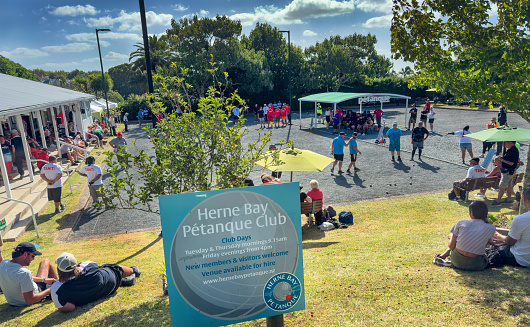 Herne Bay, Auckland, New Zealand, February 4, 2024: The New Zealand International Open Triples Pétanque Tournament. People enjoying playing and watching pétanque on a summer's day.