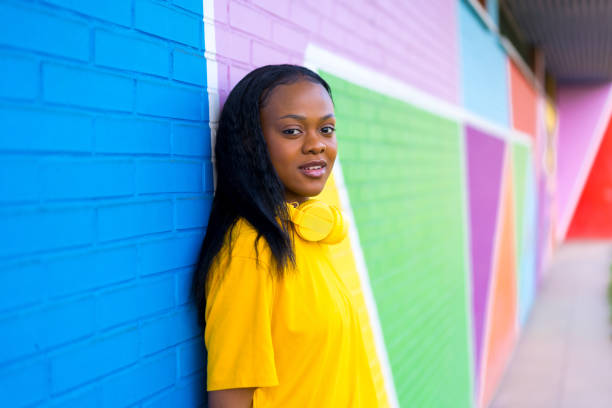 istock Cool african woman leaning on a colorful wall 1984522891