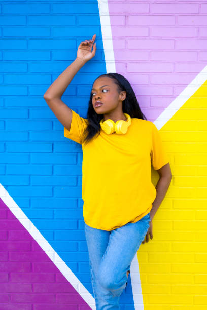 istock African young woman posing standing on a colorful wall 1984522893