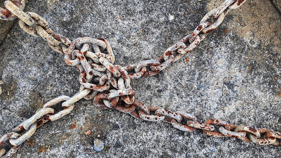 Rusty chains tangled up on the floor