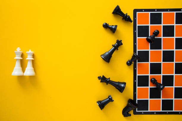 istock Top view chessboard on yellow background - Winner and Loser 1984568541