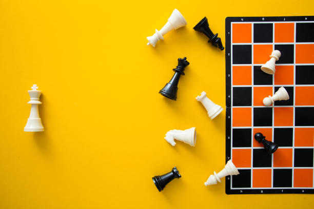 istock Top view chessboard on yellow background - Winner and Loser 1984571152