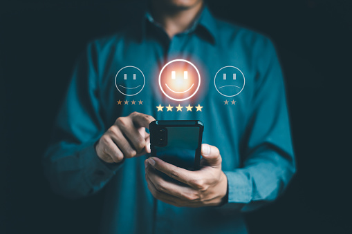 Satisfaction reviewer, evaluation, survey customer concept. Man touching mobile choose Happy and Smile checkbox with 5 star rating. Good feedback, good mood, Excellent expression, take care health.