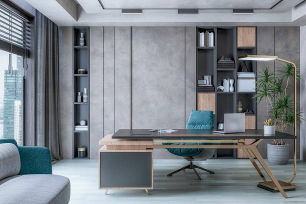 istock A director's office interior with a work desk in front of a concrete gray wall, a library with and copy space, a potted plant, a sofa and large windows with cityscape view 1984642831