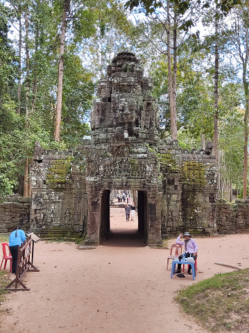 Local people outside Ta Som temple's Gopura (entrance way). Ta Som is a small temple at Angkor, Cambodia, built at the end of the 12th century for King Jayavarman VII.