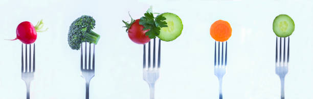 istock Vegetable stabbed on a silver fork on the white background. Close-up. 1984694471