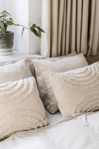 istock Decorative pillows on bed in bedroom with scandinavian interior 1984724070