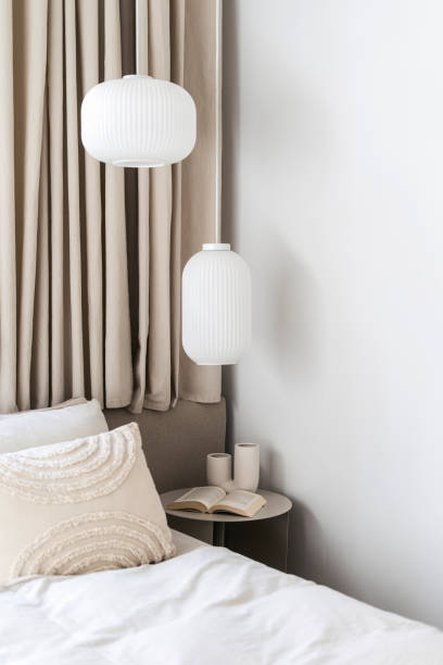 istock Cozy bedroom with bed, night side table and modern pendant lamps 1984724076