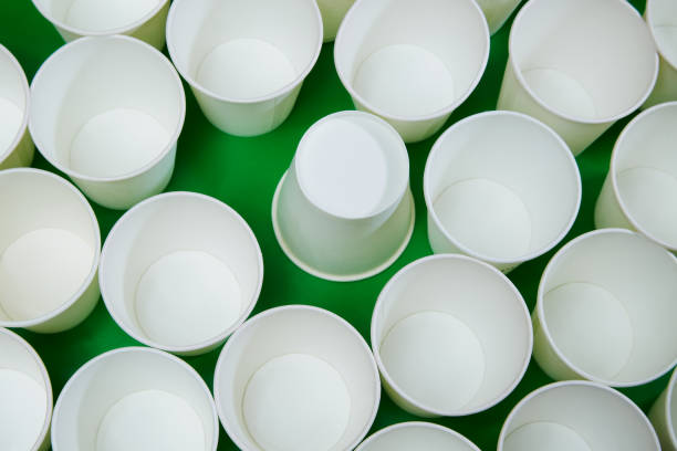 istock White empty paper cups, one of which is turned upside down. One of all, error in statistics 1984767033