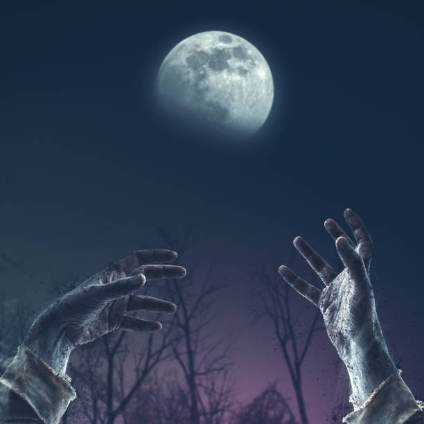 istock Zombie hands rising in the night 1984768987