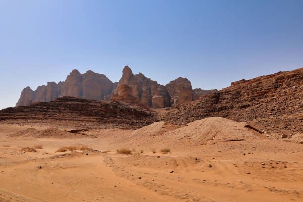istock orange sand and rocky mountains on wadi rum desert 1984780629