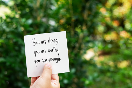 Piece of paper with text you are strong, your are worthy, you are enough