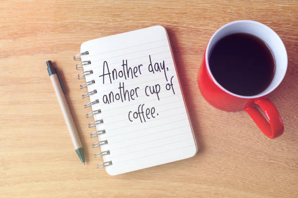 istock Notepad and coffee with quotes another day, another cup of coffee 1984795296