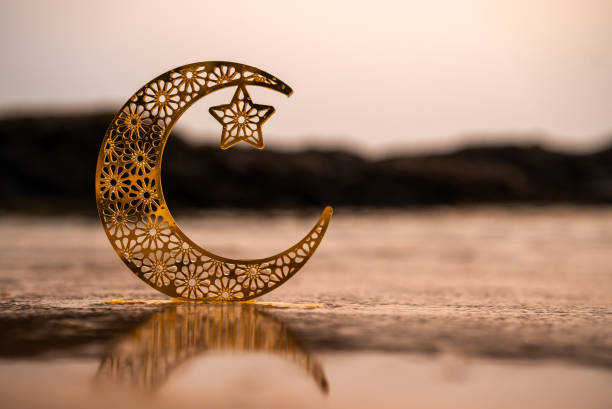 crescent moon shape on the beach, 2024 eid mubarak theme, golden moon,Half moon isolated on seascape background, 2024 Ramadan concept poster image with copy space for text