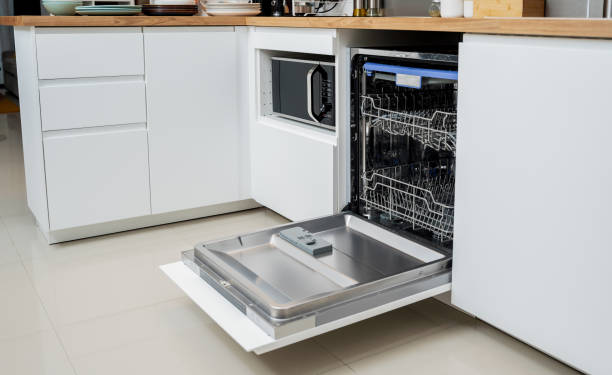 istock The white kitchen and opened dishwasher with clean dishes 1984803106
