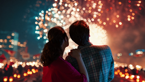 Happy loving couple watching fireworks.