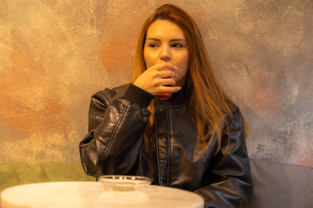 Beautiful young lady is drinking hot tea at cafe.Istanbul - Turkey.