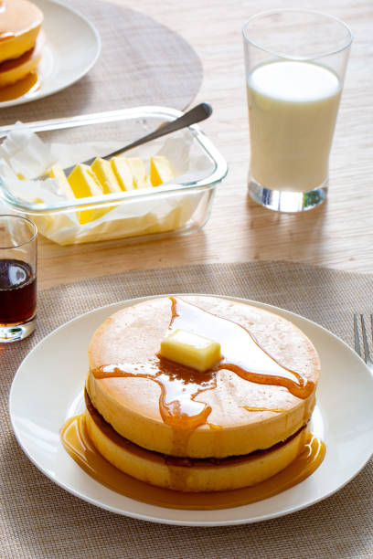fresh hot pancakes with butter in a plate, delicious cooked pancakes with cottage cheese and melted butter