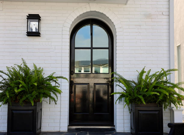 Arched Dutch door on a white brick building