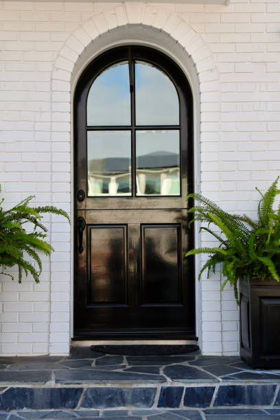 istock Arched Dutch door on a white brick building 1984852416