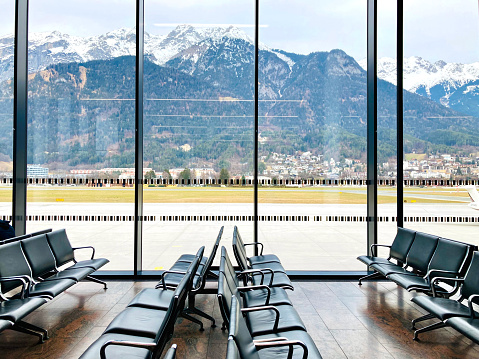 Interior of the Innsbruck Airport in Austria with the scenic view of snow-capped Alps