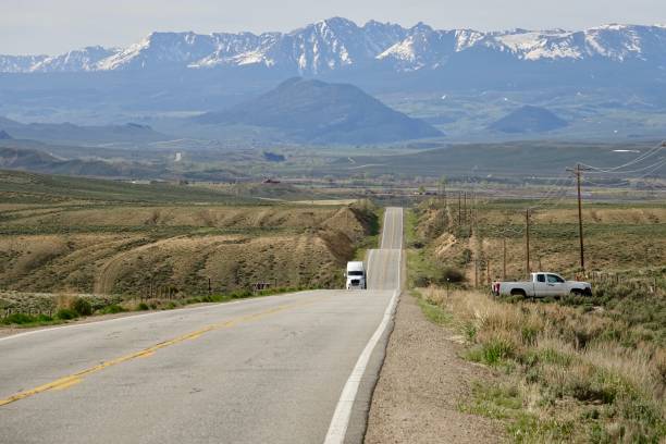 istock Long two lane highway rolling across the valley 1984856605