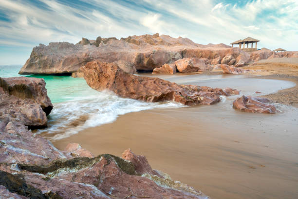 Balochistan, Pakistan - January 16, 2024: Breezy Morning Gadani Beach with rocks and mountain