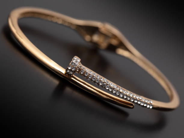 istock Gold bracelet isolated on black background 1984866111