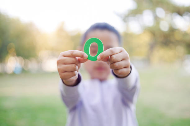 istock Child Holding Number 0 1984902908