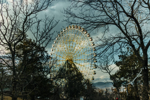 Ferris wheel in mtatsminda park during golden hour , Tbilisi, Georgia