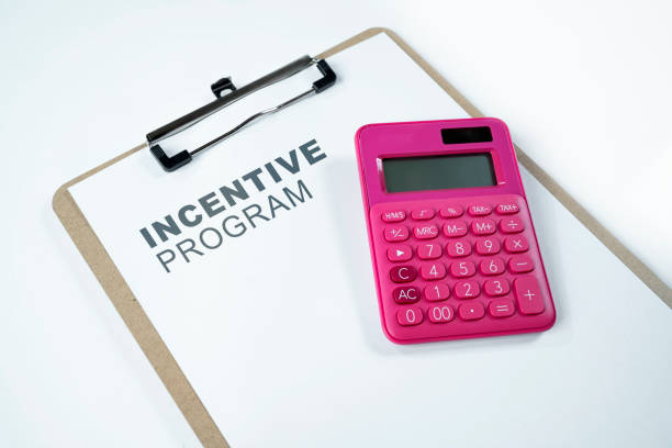 istock Calculator and clipboard with an incentive program text on the paper 1984907966
