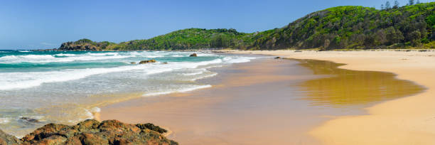 istock Australian coast with rocks on the seafront with a long sandy beach, view from the beach to the seaside landscape on a summer sunny day. 1984907978
