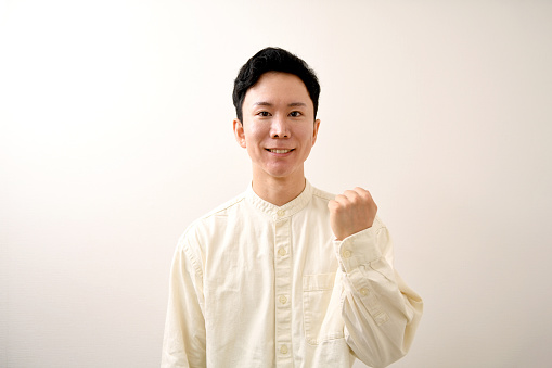 Young Asian man doing a fist pump