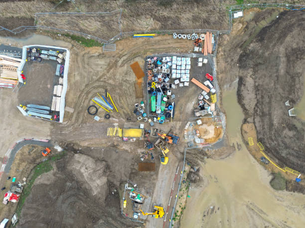 istock Drone top down view of parked up construction vehicles and materials. 1984947039