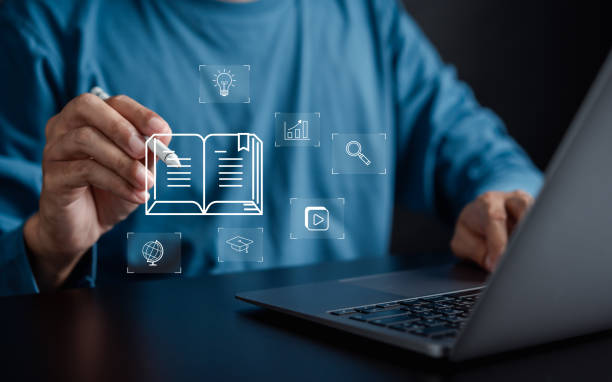 istock Man touching virtual book online classroom education and seminar with learning icon. 1984974899