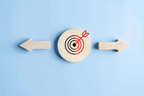 istock Dartboard with arrow and different direction facing opposite direction for business disruption and technology transformation. 1984975478