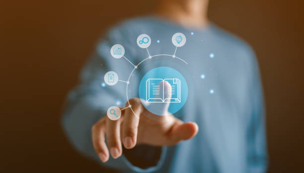 istock Man touching virtual book online classroom education and seminar with learning icon. 1984976560