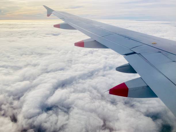 istock Airplane wing in the sky over the clouds 1984985674