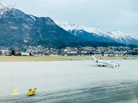 Innsbruck Airport runway in Austria with the scenic view of snow-capped Alps