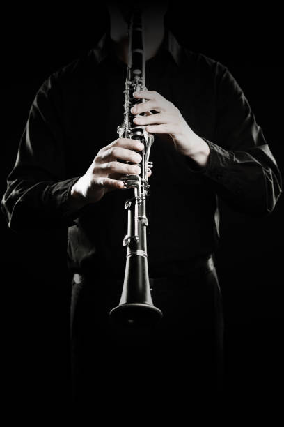 istock Clarinet player. Clarinetist hands playing woodwind instrument 1985040556