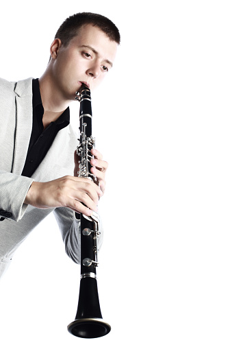 Young man playing flute.  Copy space. 