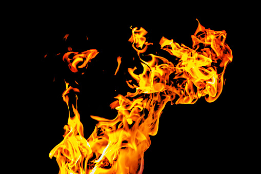 Realistic fiery explosion busting over a black background