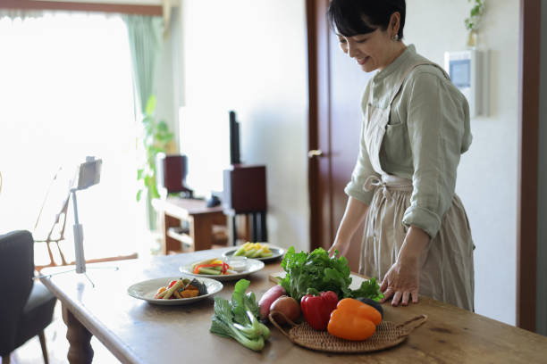 istock Woman making cooking class on smartphone mobile app 1985082101