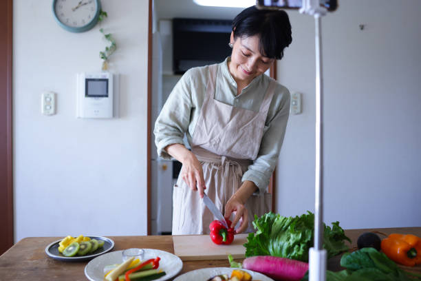 istock Woman making cooking class on smartphone mobile app 1985082106