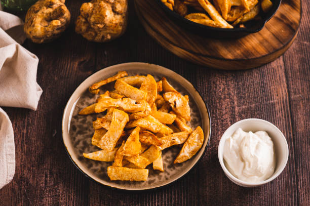 istock Fried celery root on a plate and sauce in a bowl on the table 1985085940
