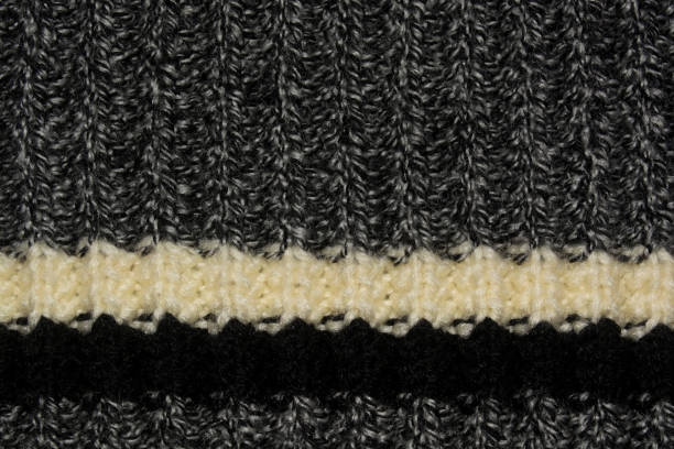 istock Dark gray knitted cloth with white and black stripes. Texture of the knitted web 1985104849