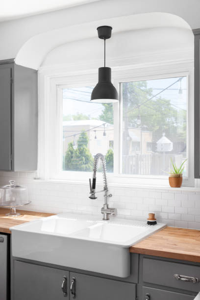 istock A grey kitchen detail with a farmhouse sink. 1985127948
