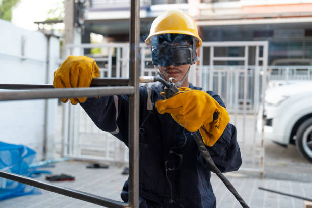 istock Asian worker wearing safety suit uses MIG welding machine. 1985161151